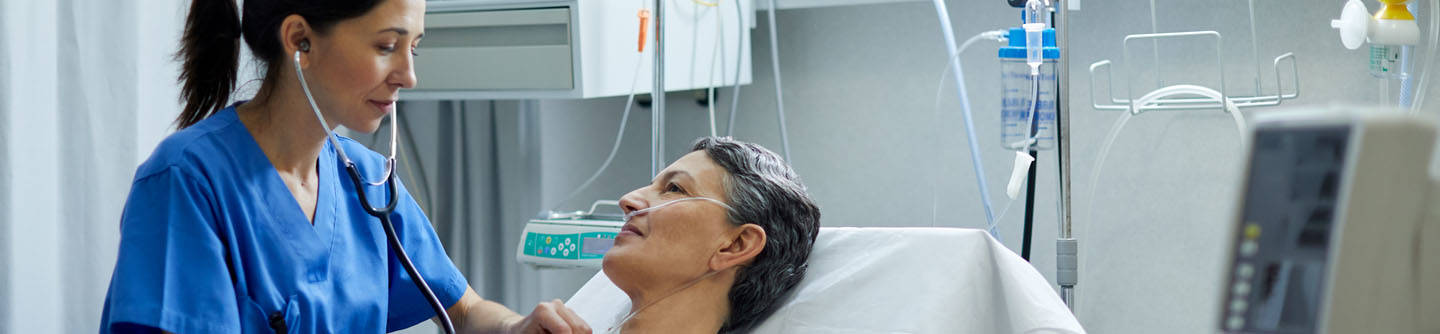 Nurse bedside with patient