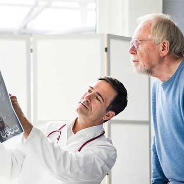 Doctor sharing brain scan image with patient thumbnail Photo of Providence Primary Care - Orenco