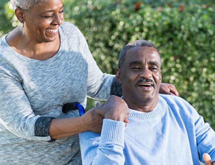 An older couple; one is in a wheel chair.