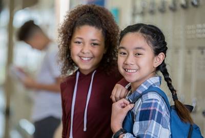 Two girls in hallway at middle school