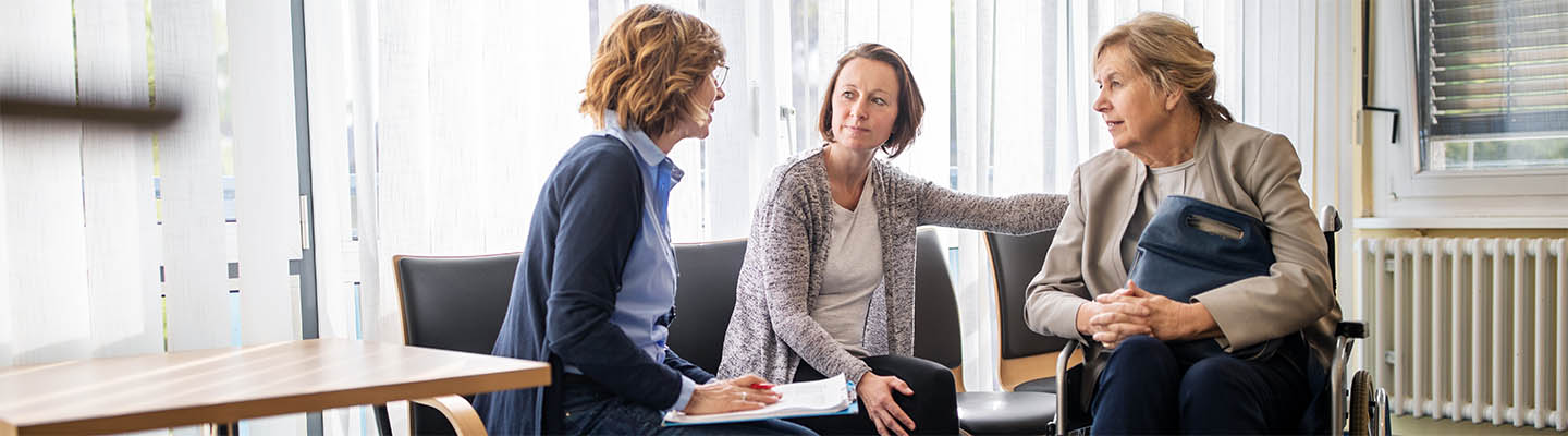 woman in wheelchair and daughter meet with therapist