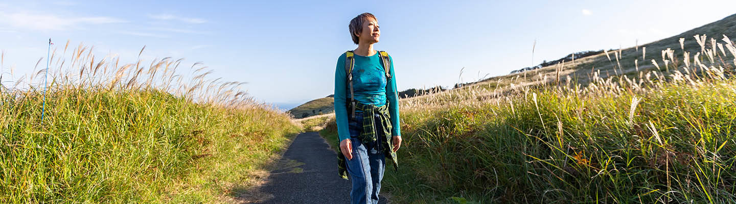 young woman hiking in meadow