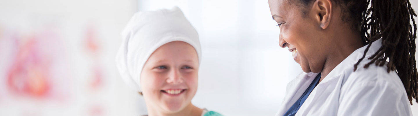 A child with head band with a female provider