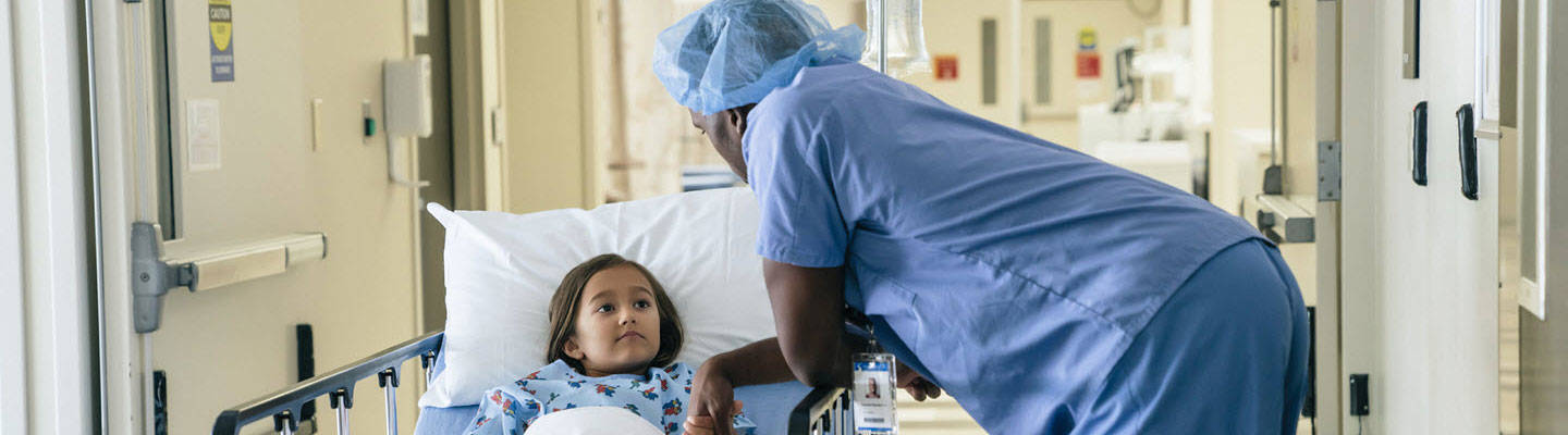 Doctor holding young girl before surgery
