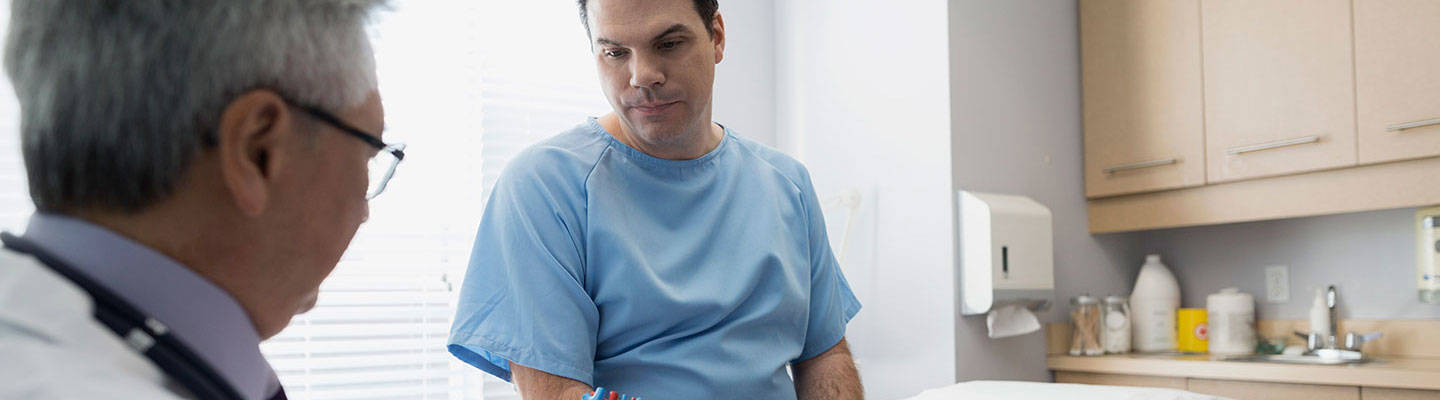 A cardiologist consults with a heart surgery patient.