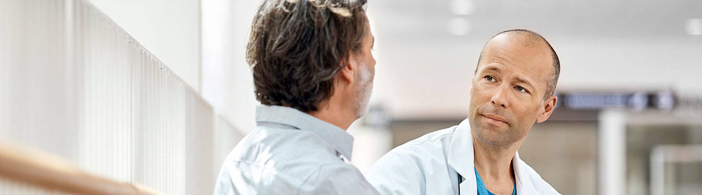 Male doctor looking at male patient