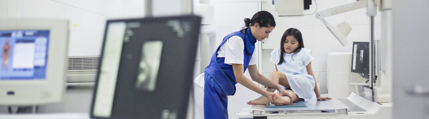 technician positions girl for xray