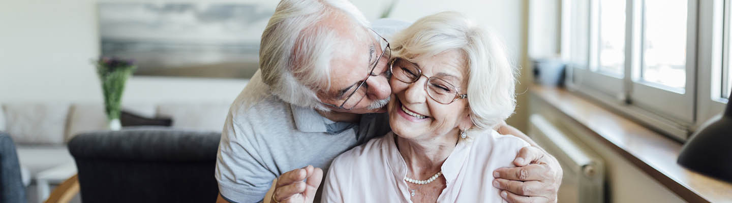 elderly man kissing woman's cheek