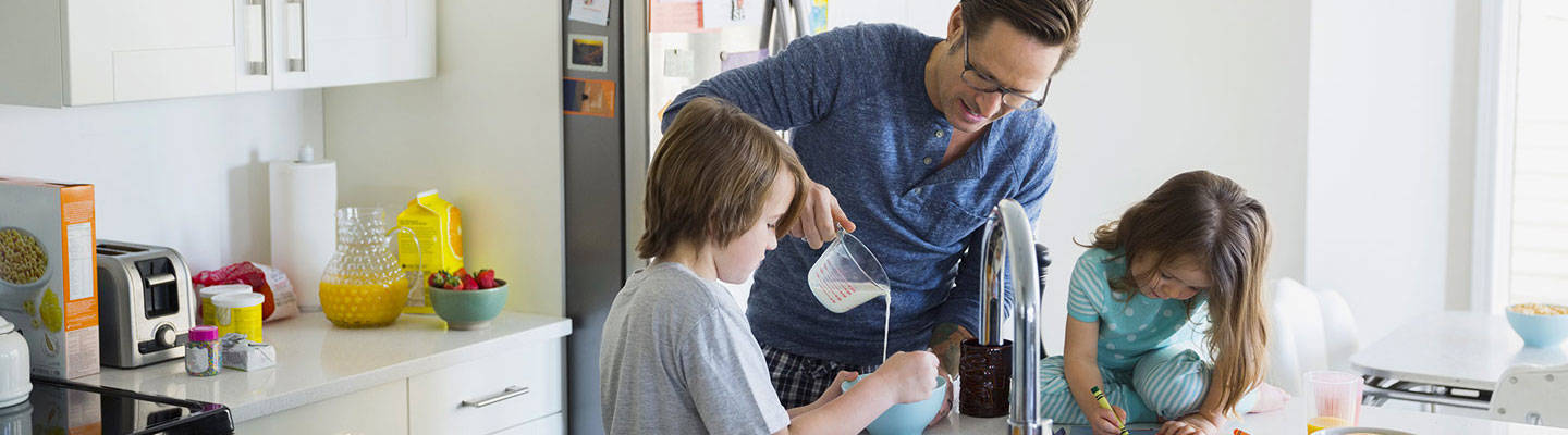 Man and two kids preparing breakfast