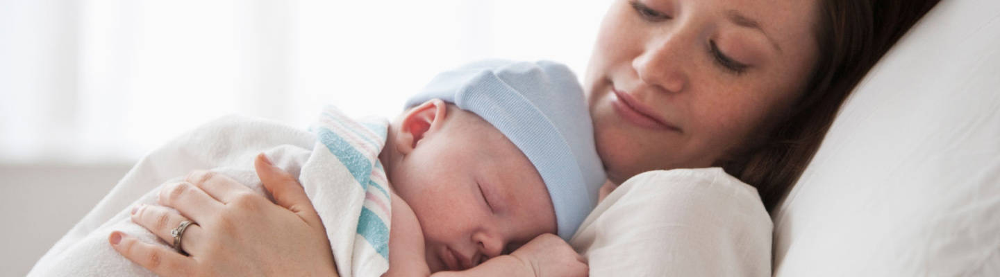 Mom with sleeping newborn baby