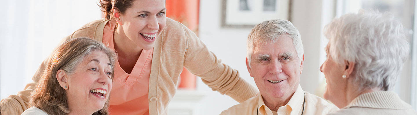 A group of seniors discussing with a caregiver