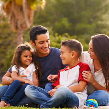 Hispanic family at park Photo of Providence Primary Care - Stewart Meadows