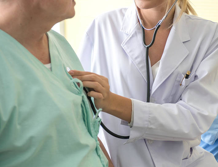 Doctor listening to patient's heart with a stethoscope