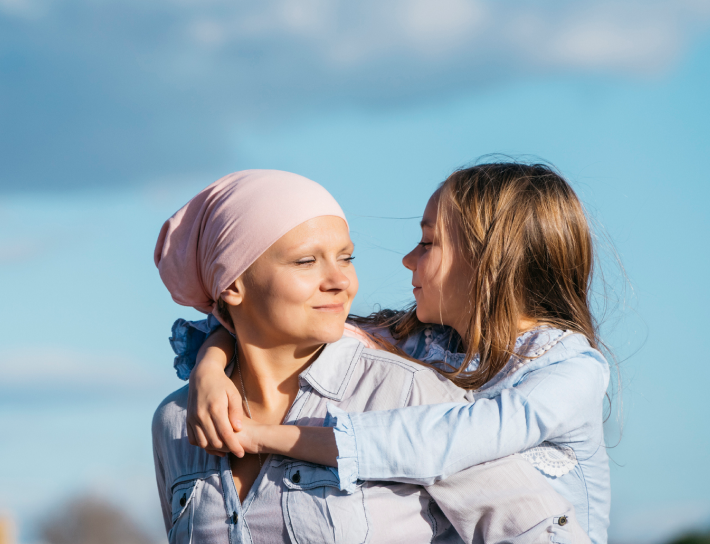 Mother and daughter outdoors piggy back ride