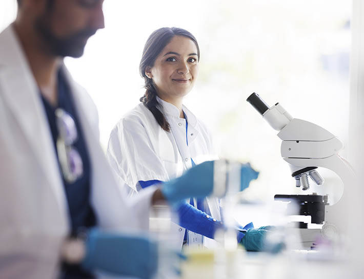pathologist smiling in a lab