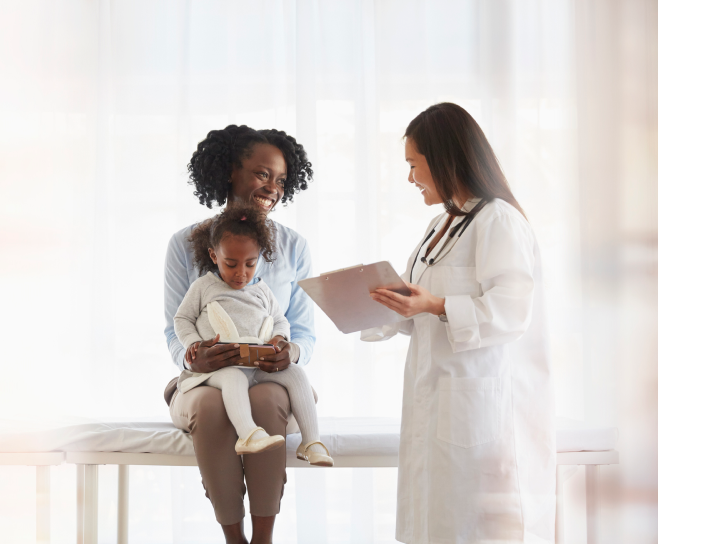 Woman and child with doctor holding chart