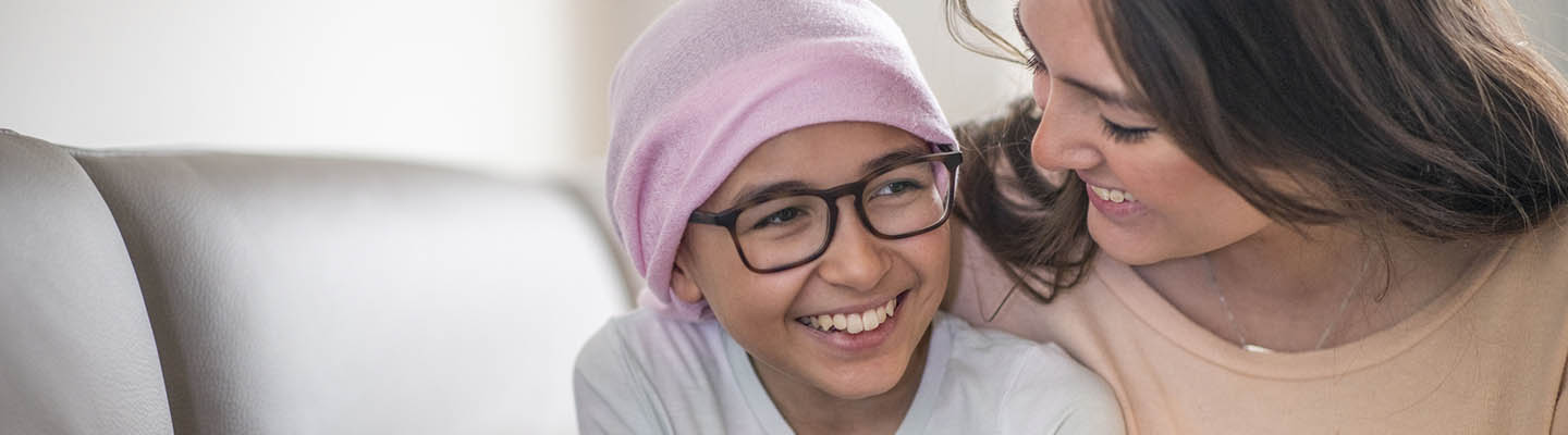 child wearing head covering with mother