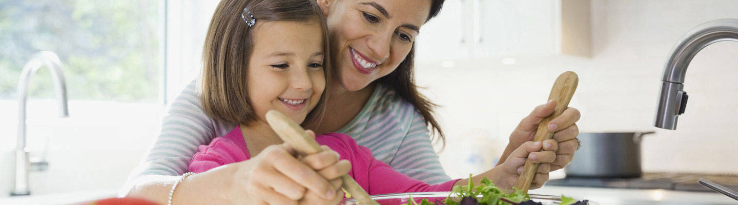 A mother prepares a meal with her daughter