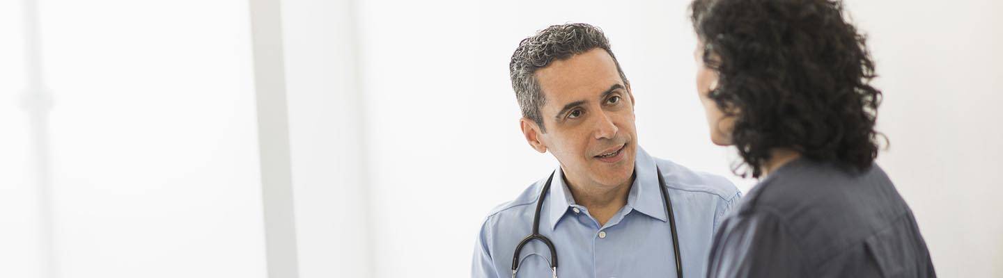 Doctor talks to patient in office