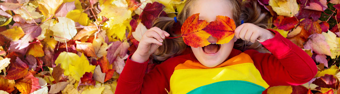 girl lying in fall leaves