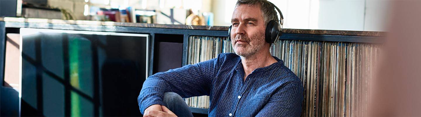 mature man listening to music on headphones