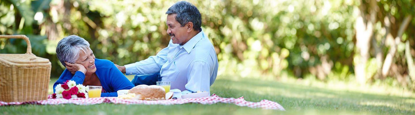 senior couple enjoying a picnic together outdoors