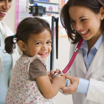Doctor showing a stethoscope to a little girl Photo of Providence Medical Institute - Torrance Pediatrics
